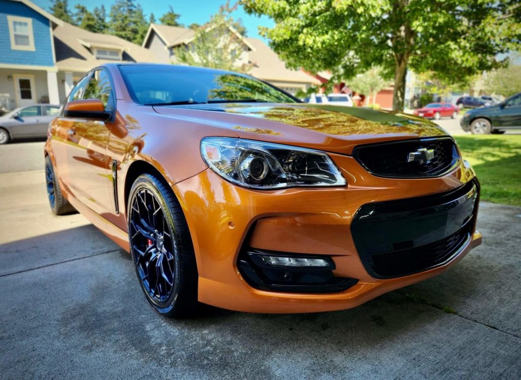 an orange car that has been washed and waxed with our detailing service