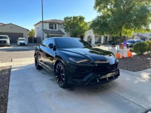 a black Lamborghini Urus after receiving an exterior hand wash