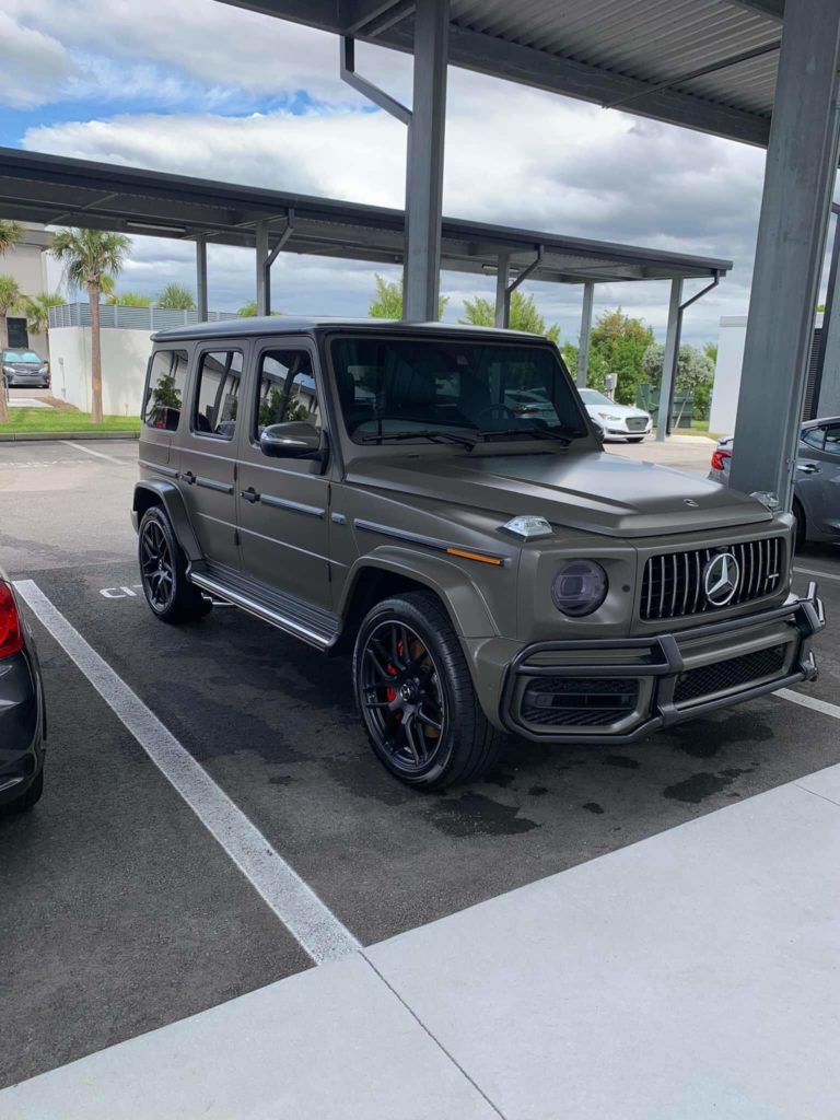 a green Mercedes SUV parked outside