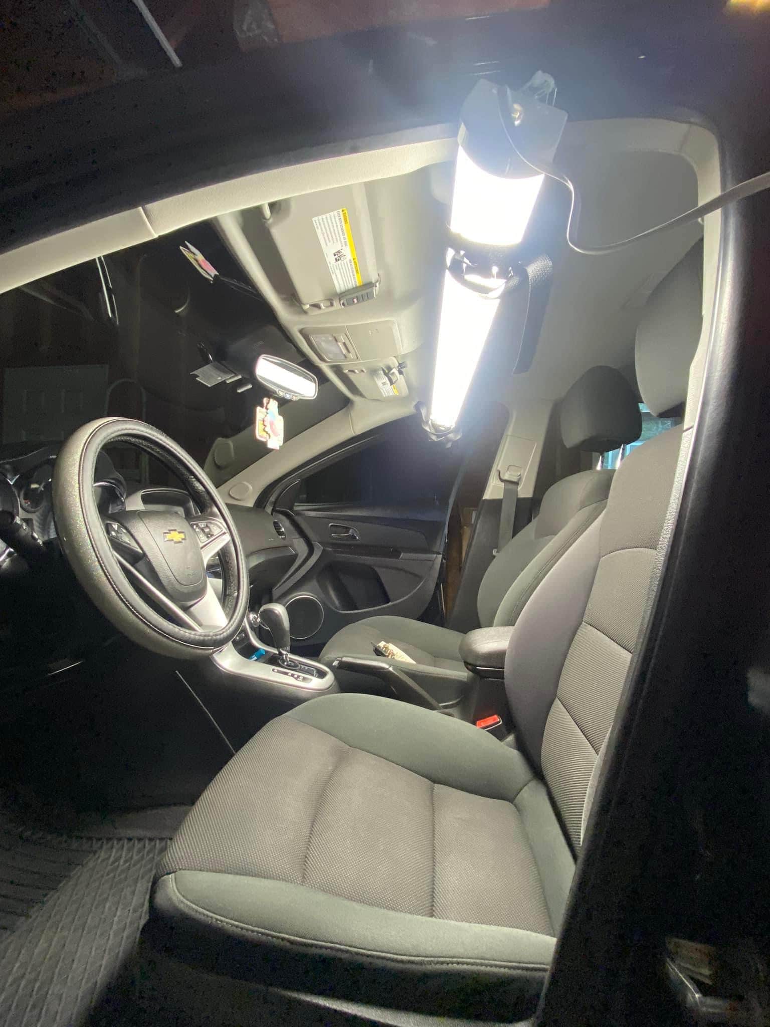 the interior of a car being detailed using a bright LED light