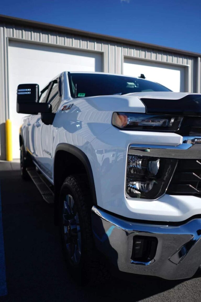 a white Chevy Truck in a parking spot