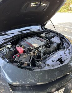 a dodge charger engine bay after being washed