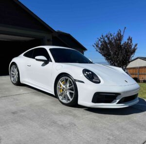 a white Porsche 911 that has just been washed and waxed