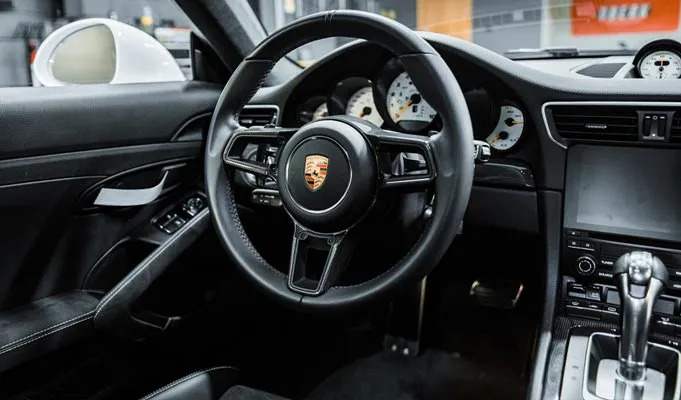 a Porsche sports car interior after getting detailed by TopShine Mobile Detailing