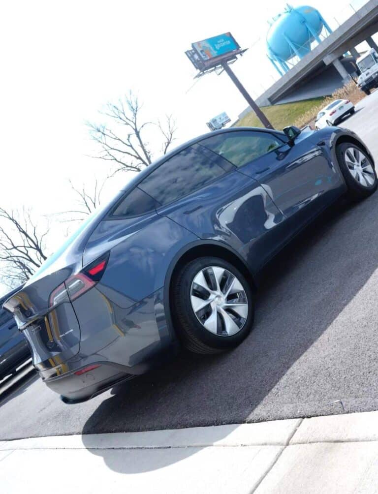 a grey model Y looking shiny in a parking lot