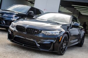 a black BMW sedan looking extra shiny post ceramic service