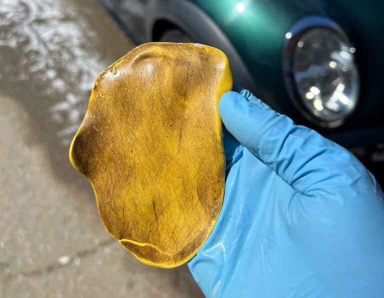 a used clay bar after decontaminating a car