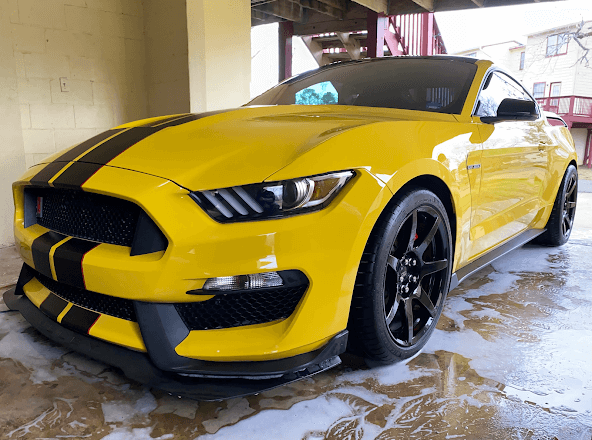 a yellow mustang that has received our signature wash & wax service