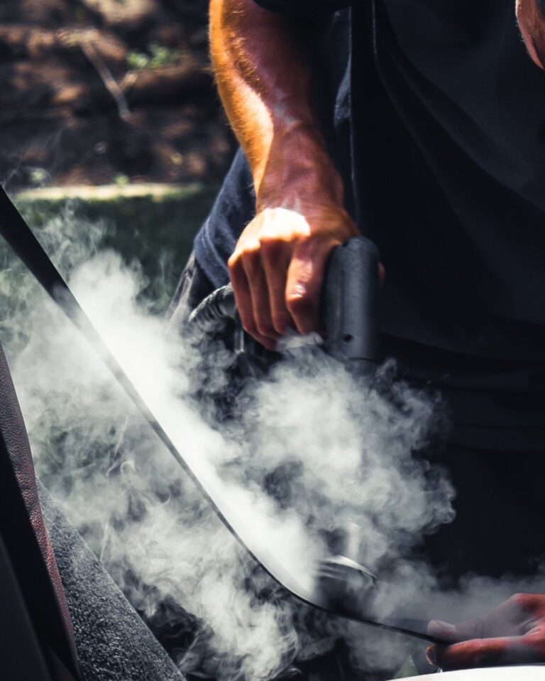 a black car seatbelt being steam cleaned