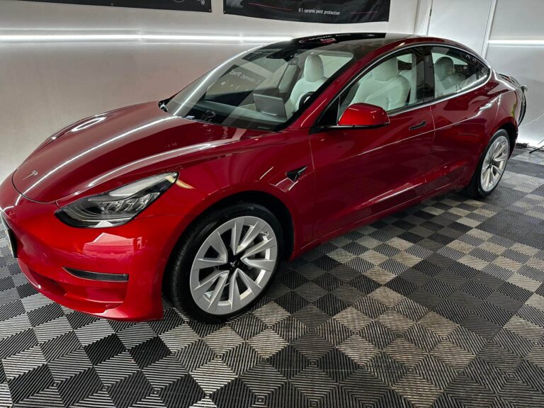 a red Tesla Model 3 after ceramic coating installation