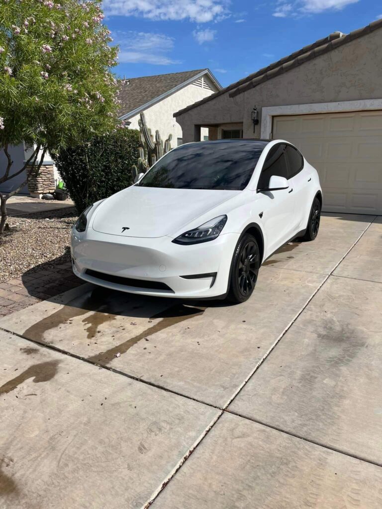 a white Tesla sedan parked after getting polished