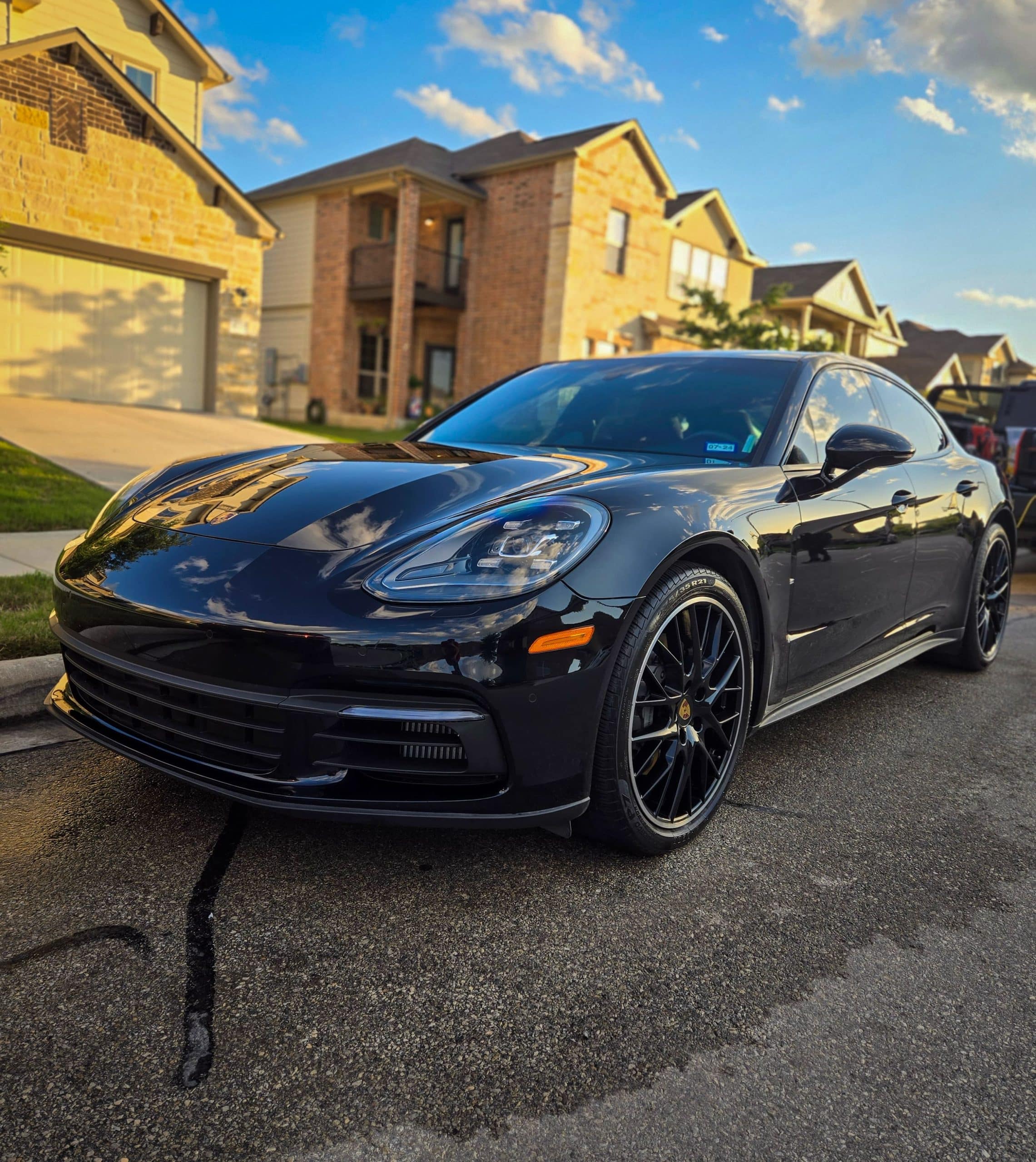 black Porsche Taycan after receiving its weekly car wash service